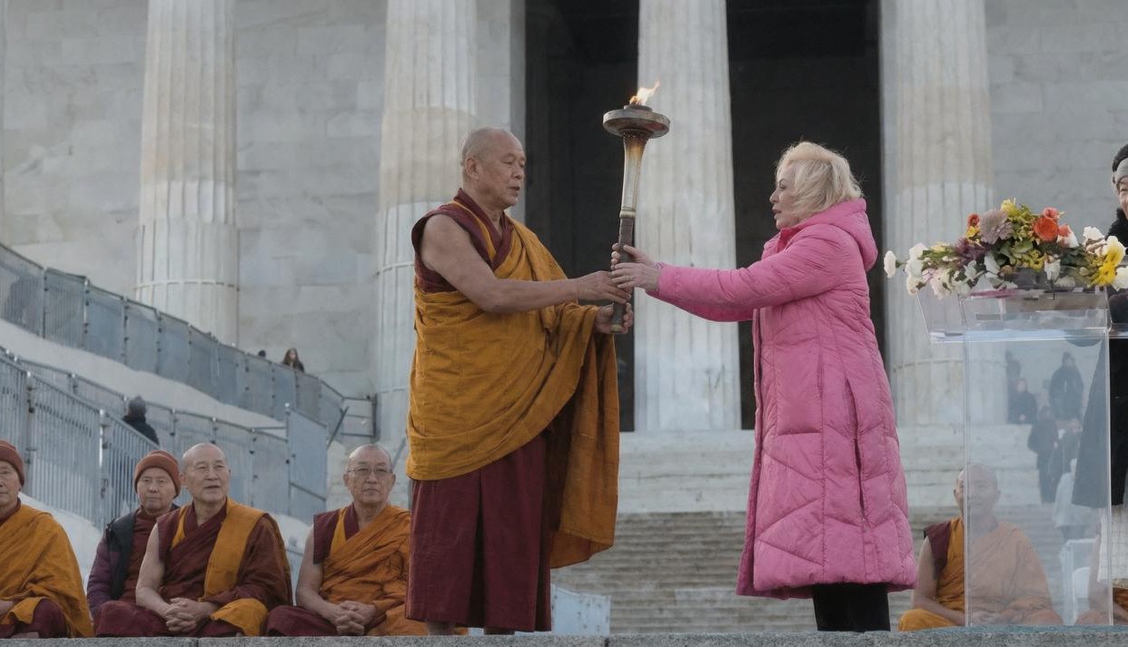 Dr. Nina Meyerhof passing the ceremonial flame at the Lincoln Memorial